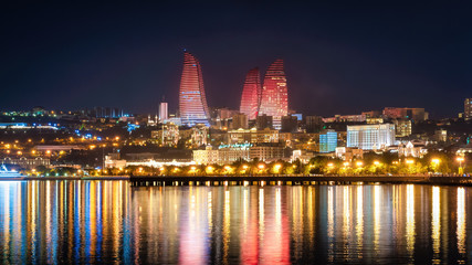 Fototapeta premium Baku, Azerbaijan - July 2019: Flame Towers in night cityscape. The facades of Flame Towers function as large display screens with the use of more than 10,000 high-power LED luminaires