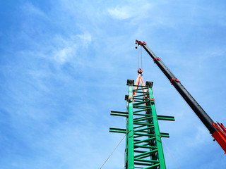 Man Working on the Working at height on construction site with blue sky
