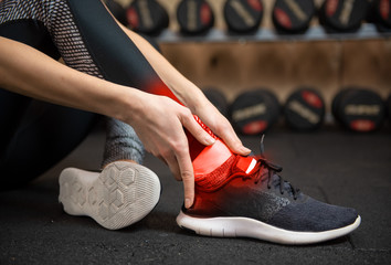 Woman with ankle injury in gym