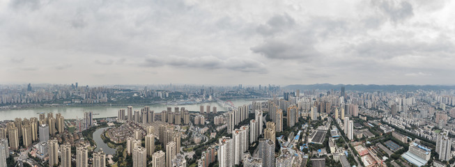 Aerial pano pano drone shot of populated residence buildings alng Yangtze river in Chongqing, southwest China metropolis
