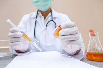 Professional doctors perform testing and analyzing samples of COVID-19 vaccines for immunization prevention and treatment from viral infections. Medical and health care concepts