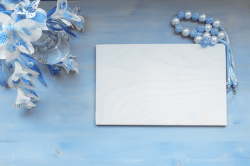Blue frame on wooden background with flowers in blue color toned, copy space, text place. Classic blue Color of 2020 year.