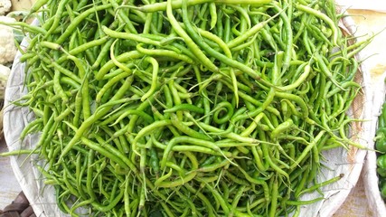 Green chilies in the basket for sale