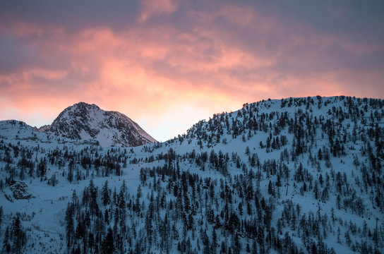 Pretty sunset over snowy mountains in a ski resort in the French Alps