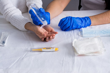 Hand sanitizer alcohol gel rub clean hands hygiene prevention of coronavirus virus outbreak. Nurse and patient using bottle of antibacterial sanitiser soap.