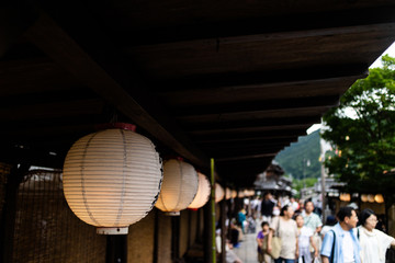 traditional lanterns hung alongside a busy street