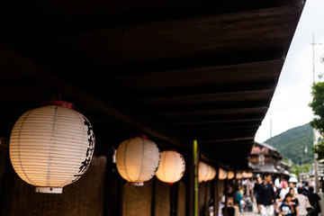traditional lanterns hung alongside a busy street
