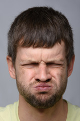 Obraz premium Portrait of a man who really does not like the smell, European appearance and close-up