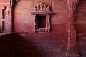Carved indian red walls of Fatefpur Sikri Palace - UNESCO Wolrd heritage site from 16th century
