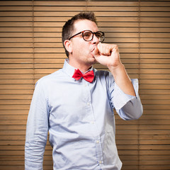 Man wearing a red bow tie. Coughing.