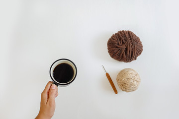 cup of coffee and yarns ball on either background 