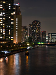High rise buildings in Tokyo reflected in a river