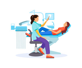 Dentist doctor examining patient girl lying at dentistry office chair.