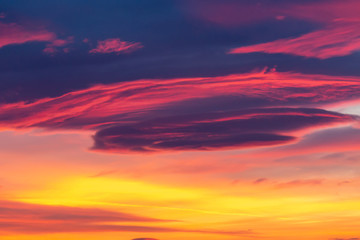 Fototapeta premium Dramatic sky background in purple, pink and orange hues. Abstract natural sunset skies skyscape, peaceful scenery in vivid colors, horizontal shot