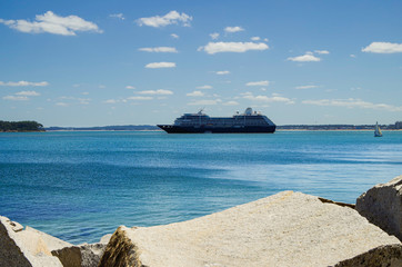 Luxury cruiseship or cruise ship liner Azamara Pursuit anchors in bay on blue sea during summer...