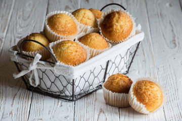 cupcakes in a basket on a rustic white wooden board, space for copying, selective focus