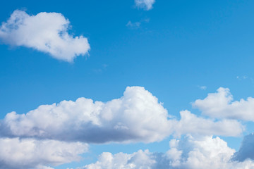 Naklejka na ściany i meble big white cumulus clouds in the blue sky as a natural background