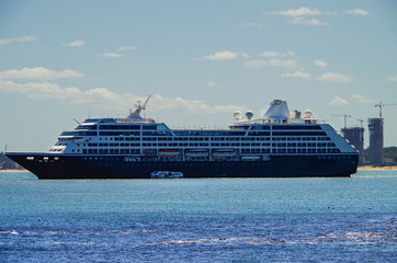 Luxury cruiseship or cruise ship liner Azamara Pursuit anchors in bay on blue sea during summer...
