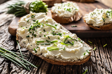 Close-up of bread slice with traditional Slovak bryndza spread made of sheep cheese with freshly...