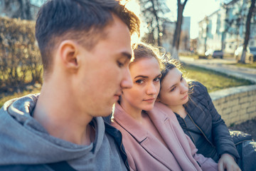 Fototapeta premium girl with girlfriend meet one guy. love triangle.