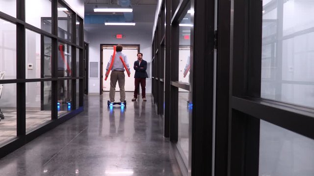 Goofy Employee Pool Noodle Skiing on a Hoverboard Down a Hallway.