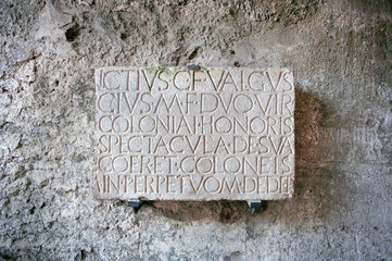 Roman inscription at the entrance to the amphitheater in the ancient city of Pompeii, Italy