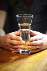 mens hands holding a glass