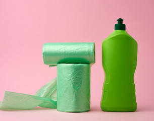 roll with transparent bags for the bin and a plastic bottle with detergent
