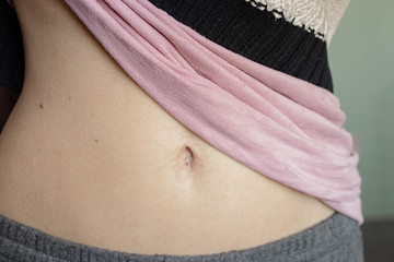 belly of a young girl with a belly button closeup at home