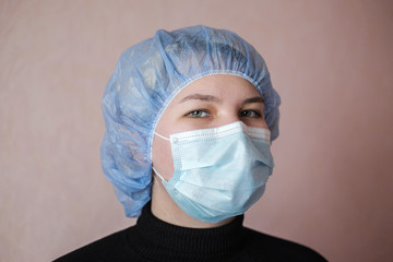 Asian woman in a protective face mask. Portrait of a young woman in a medical mask against covid-19