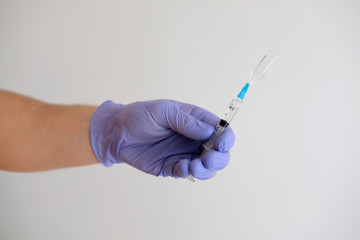 Hand holding syringe and vaccine for the covid-19 virus, against the corona epidemic / vaccine isolated on white background