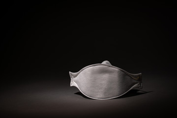 safety mask - breathing mask - respirator on dark background - covid-19 - corona