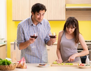 Young couple celebrating wedding anniversary at kitchen