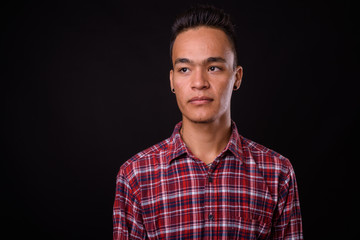 Face of young handsome Indian hipster man