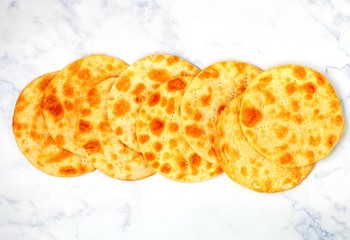 Tasty crispy baked round puff pastry layers of homemade cakes on a marble background table. selective focus, top view and copy space