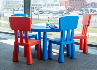 Fototapeta na wymiar Colorful furniture chairs for children in a modern office near the window. Moscow, Russia - April 14 2020