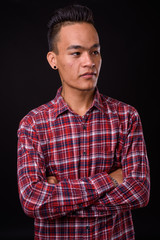 Portrait of young handsome Indian hipster man