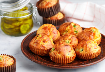 Delicious freshly baked homemade Savory muffins with Parmesan cheese, sausage or ham and green peas. Gourmet appetizer. Selective focus