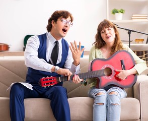 Young woman during music lesson with male teacher