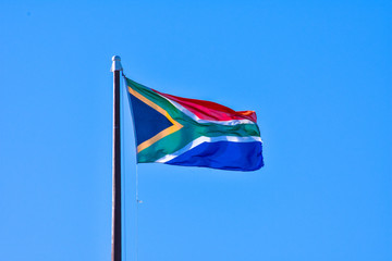 National flag of South Africa with a blue sky