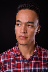 Obraz premium Face of young handsome Indian hipster man