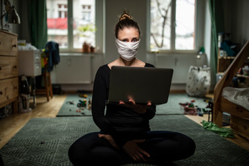 Woman with a mask in home office during Corona Virus time