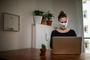 Woman with a mask in home office during Corona Virus time