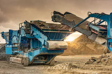 Excavator collecting stone in an open-cast mine
