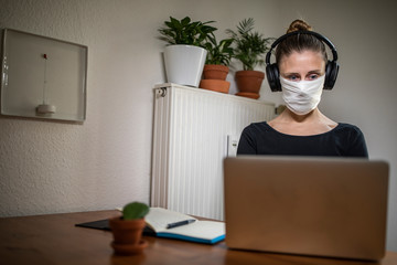 Woman with a mask in home office during Corona Virus time