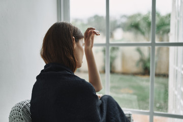 young woman looking at the window