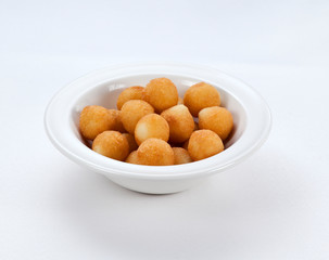 cheese balls in a plate on a white background