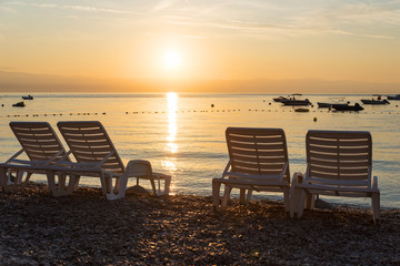 empty sunbed chairs at gravel beach moscenicka draga croatia, sunrise scenery
