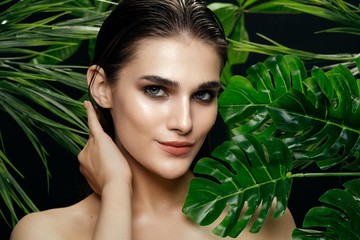 beautiful woman naked shoulders green leaves delicate makeup