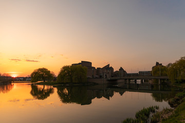 View on the river Meuse and Maastricht landscape with a view on St Pietersberh and Gouvernement building during sunset in april